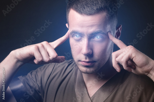Canvas Print Caucasian man with glowing eyes reads your mind