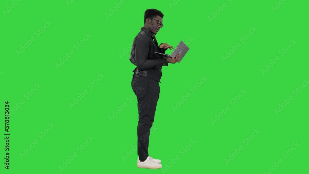 Confident African American businessman typing on laptop on a Green Screen, Chroma Key. Confident African American businessman typing on laptop on a Green Screen, Chroma Key.