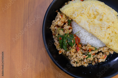 Rice with stir fried pork and basil topped with thai omelette.