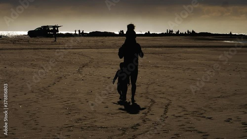 Dad and kids on a sunset walk by the beach - Snapper Rocks Gold Coast Australia