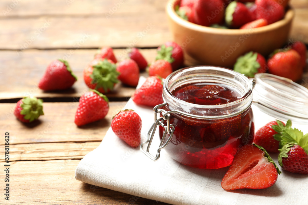 Delicious pickled strawberry jam and fresh berries on wooden table Delicious pickled strawberry jam and fresh berries on wooden table