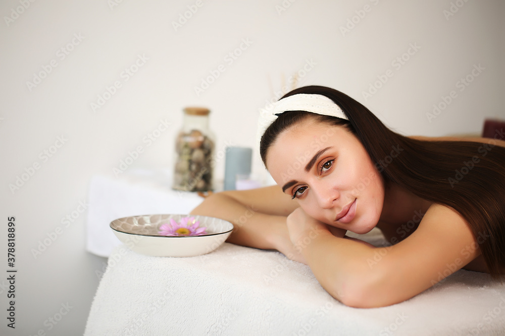 Naklejka premium Beautiful young woman in a spa, brunette