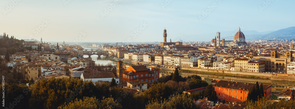 Sunset winter panorama of Florence, Italy, in golden sunlight, with the Arno river and the dome of the cathedral of Santa Maria del Fiore