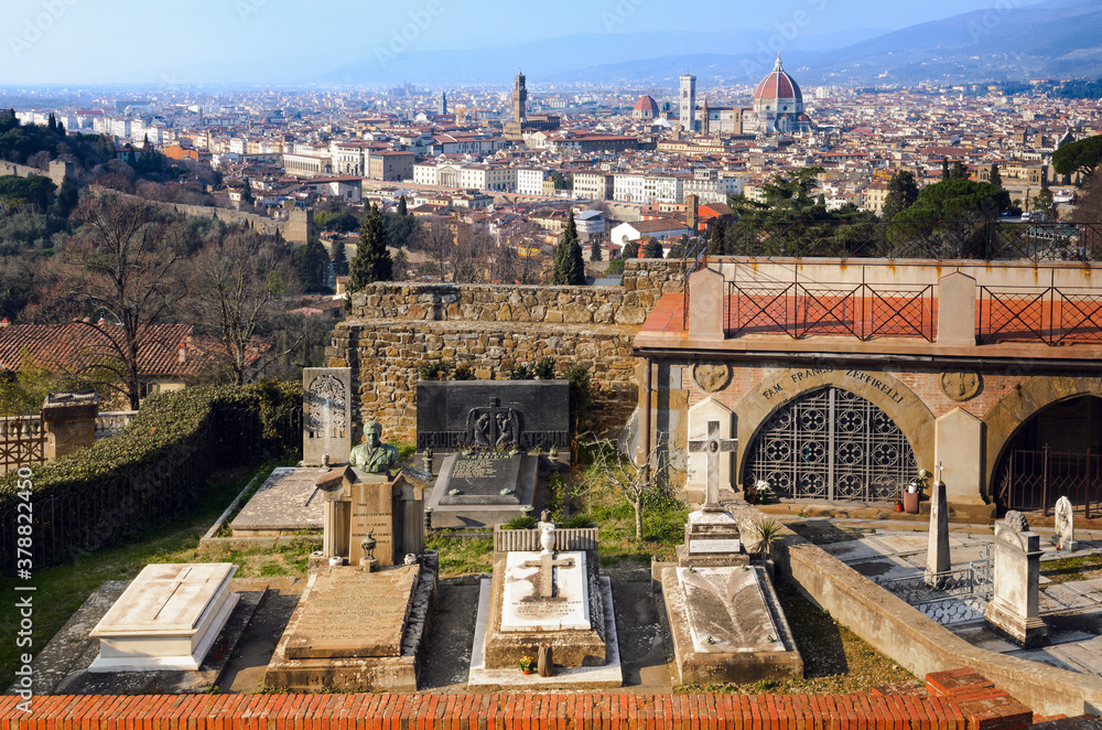 The San Miniato al Monte cemetery in Florence, Italy, with the tomb of the famous italian movie director Franco Zeffirelli and the city in background