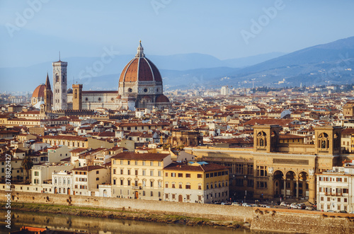 Sunset winter panorama of Florence  Italy  in golden sunlight  with the Arno river and the dome of the cathedral of Santa Maria del Fiore