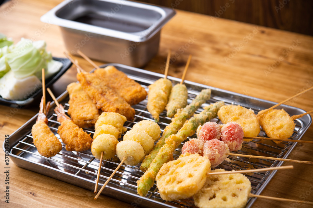 Naklejka premium Kushikatsu or Kushiage, japanese Osaka style deep fried skewers