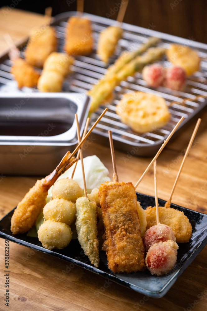 Naklejka premium Kushikatsu or Kushiage, japanese Osaka style deep fried skewers