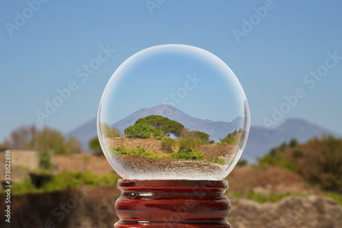 Pompeian landscape on a summer sunny day with Vesuvius in the background through a glass transparent ball 