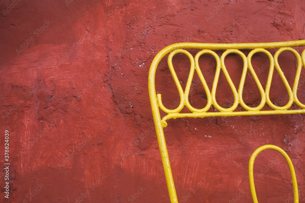 Close-up of a chair in front of a wall 