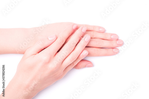 Beautiful female hands showing fresh cute manicure, skin and nail care concept, isolated © Frostroomhead