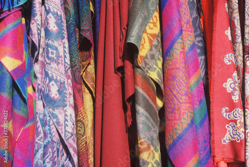 Close-up of shawls hanging in a store 