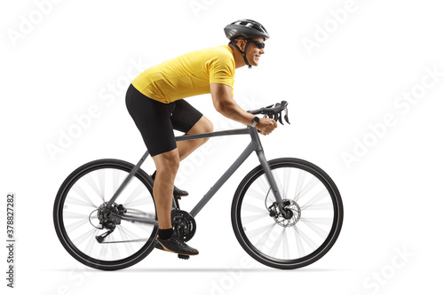 Fototapeta Naklejka Na Ścianę i Meble -  Profile shot of a guy riding a road bike