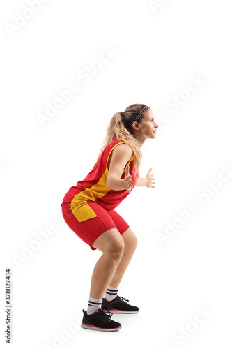 Full length profile shot of a young female defence basketball player in action