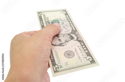 5 dollars in a female hand isolated on white background. Close-up.