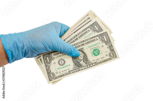 a hand in a glove holds 1 dollar bills / isolated on white / copy space.
