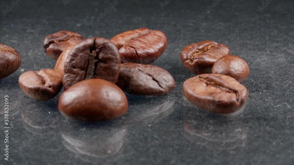 Several coffee beans on a gray background. Several coffee beans on a gray background.
