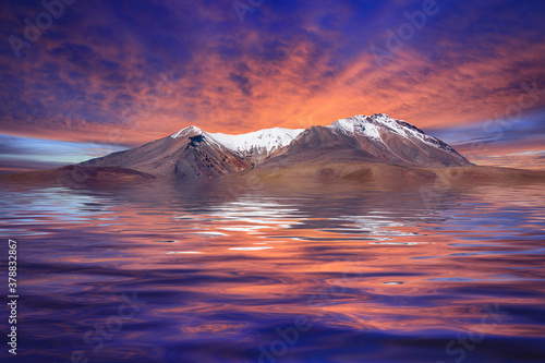 Fototapeta Naklejka Na Ścianę i Meble -  Sunrise Over an Island of Snow Covered Mountains