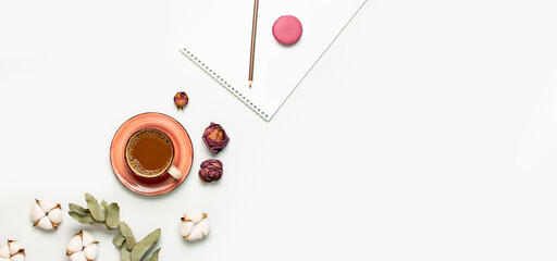 Flat lay autumn composition. Cup of coffee, cotton flowers, dry rose, eucalyptus, macaroon cake, blank notebook, pencil on white background top view. Fall concept. Delicate female desktop