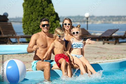 Happy family at poolside on sunny summer day © New Africa