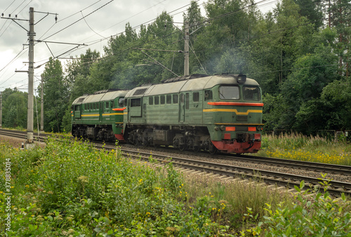 Green locomotive rides on the railway