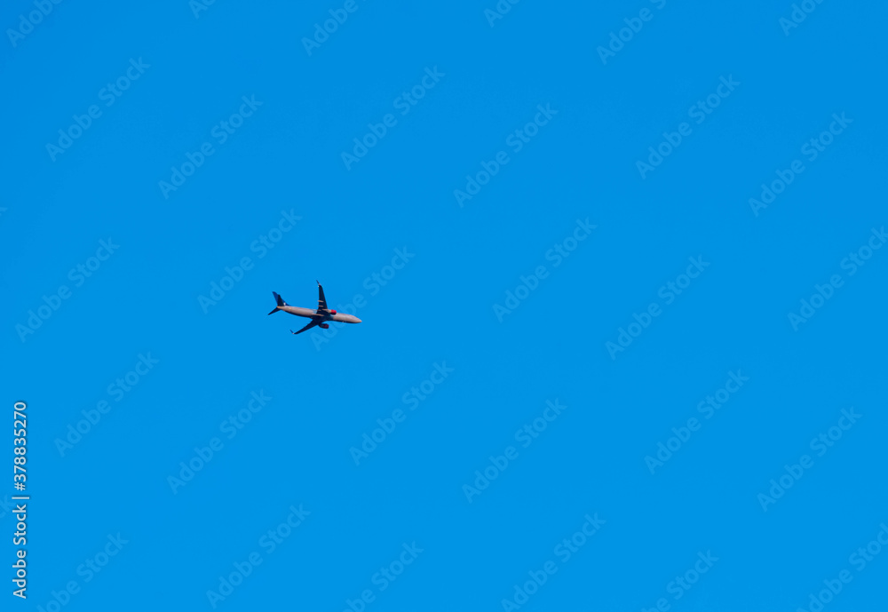 A Scandinavian airlines Boeing 737-800 flying high above the ground on route with clear blue skies. A Scandinavian airlines Boeing 737-800 flying high above the ground on route with clear blue skies.