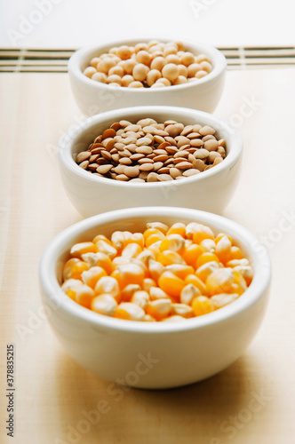 Close-up of bowls of corn and lentils with soybean