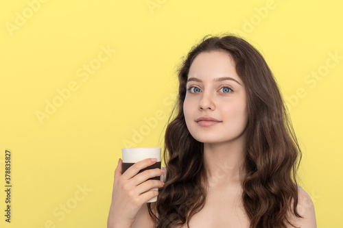 A young girl with reusable bamboo cup.