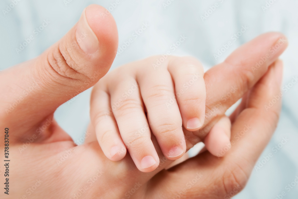 Woman holding her baby's hand Woman holding her baby's hand