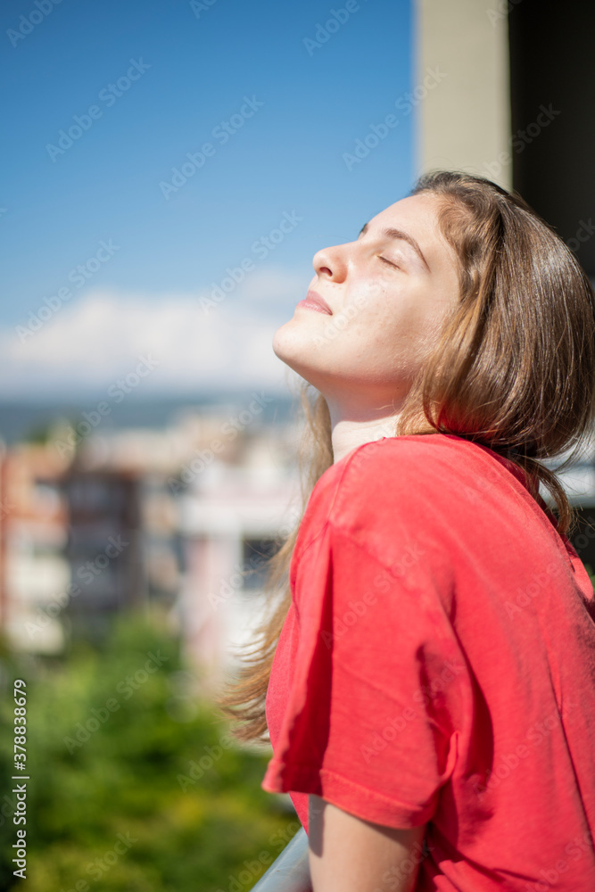 Young Girl Closing Her Eyes When the Sun Touches Her Face Young Girl Closing Her Eyes When the Sun Touches Her Face