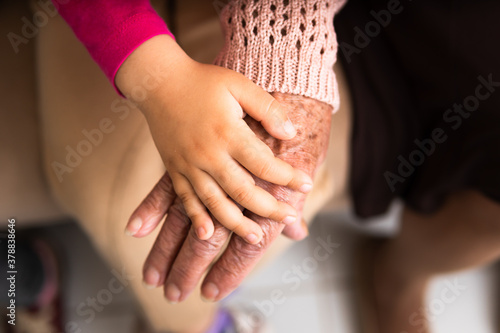 close up detail of female hands multigenerational family over each other. commitment, aging, care, support, unity concept.
