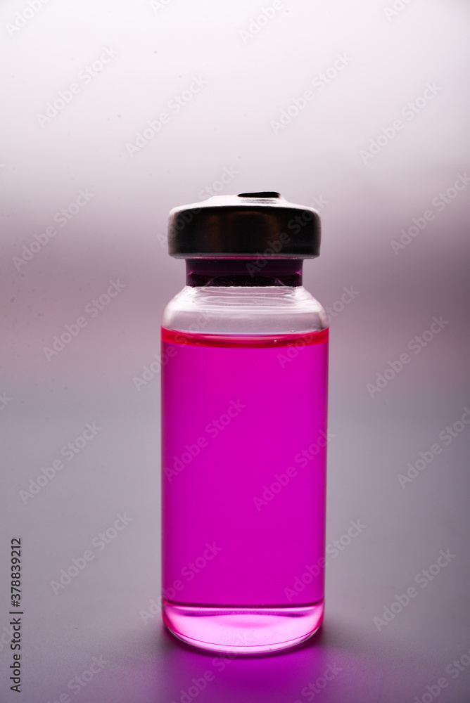Medical pink vial with solution for injection on white background Medical pink vial with solution for injection on white background
