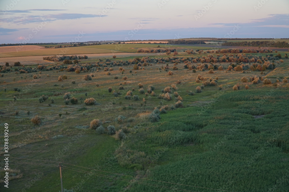 Fototapeta premium Sunset over fields in the countryside
