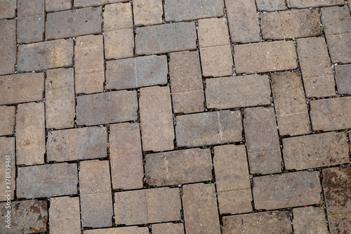 Close up of a brown cobblestone brick type pathway or driveway