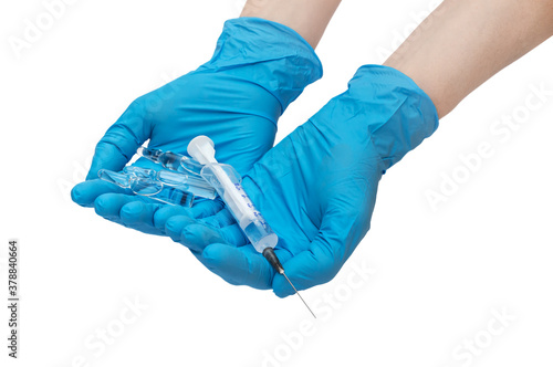Hands in medical gloves holding syringe with ampules. Isolated on white.