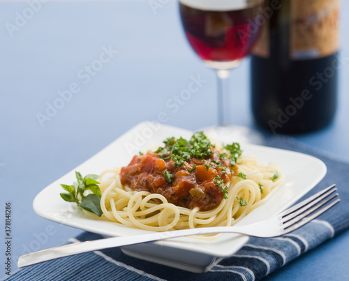 Close-up of spaghetti and meat with red wine