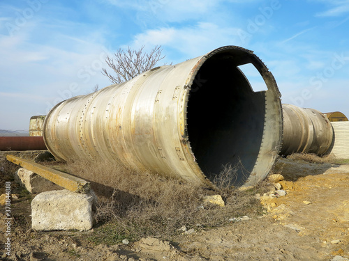 Wallpaper Mural Old rye pipes of large diameter lie on the ground. Pipeline. Large iron drainage pipes connect two reservoirs. Large diameter metal pipe for agricultural irrigation system. Torontodigital.ca