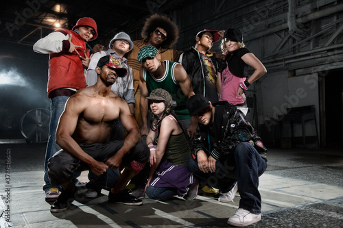 Multi-ethnic break-dancers posing in warehouse
