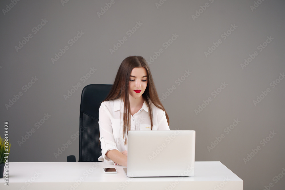 Portrait of beautiful young woman working with laptop in her office. Portrait of beautiful young woman working with laptop in her office.