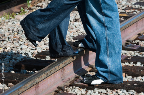 Man and Woman Legs on Railroad Track