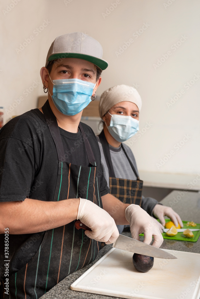 two young businessmen cooks, cooking and handling food with chinstrap