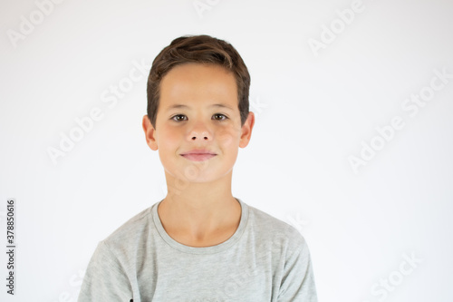 Young pretty boy posing at studio. Photo of preschooler 9 years old over white background