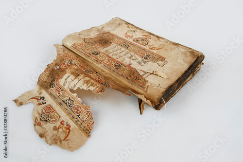 Aceh, Indonesia, 17/9/2020: An ancient mushaf Quran manuscript with Acehnese illuminations placed on a white background in Banda Aceh. photo