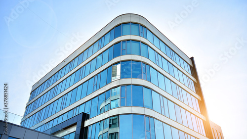 Office building, details of blue glass wall and sun reflections.