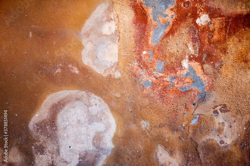 Abstract concrete, weathered with cracks and scratches. Remains of paint different colors on wall. Landscape style. Grunge Concrete Surface. Great background or texture.