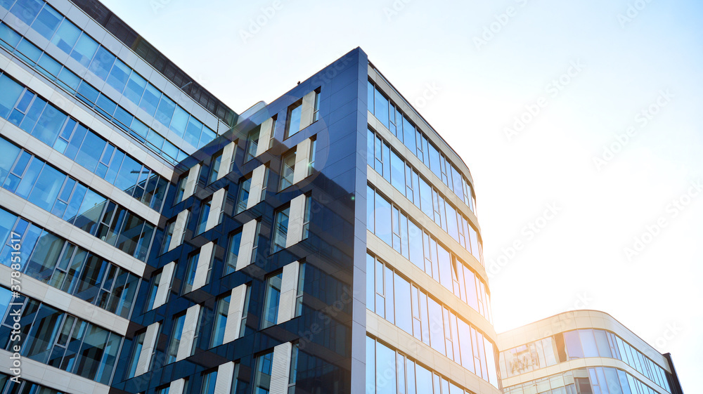 Office building, details of blue glass wall and sun reflections. Office building, details of blue glass wall and sun reflections.