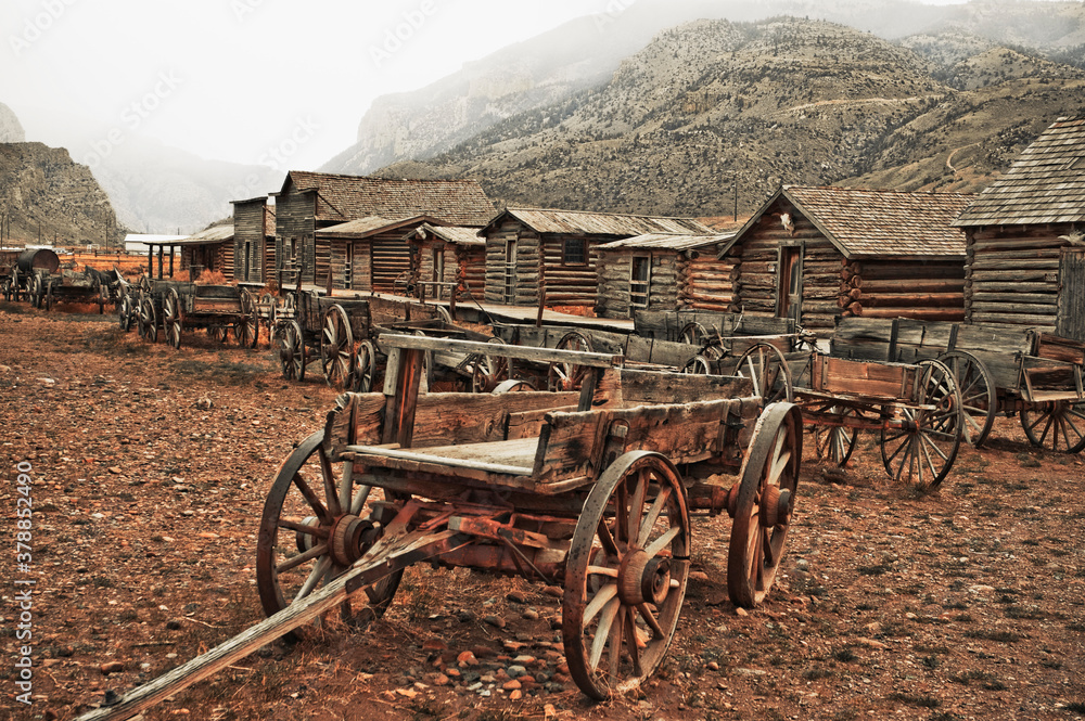 Wagons and abandoned houses in a ghost town, Old Trail Town, Cody, Wyoming, USA Stock Photo