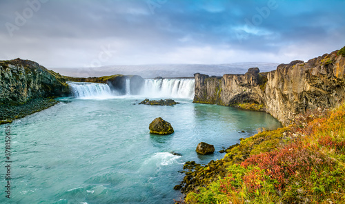 Fantastic panoramic view of powerful Godafoss waterfall. Dramatic sky over Godafoss. Location: Godafoss waterfall, Iceland, Europe. Artistic picture. Beauty world. Travel concept.