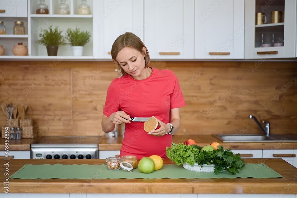 pregnant-woman-is-eating-peanut-butter-pregnancy-healthy-food-and