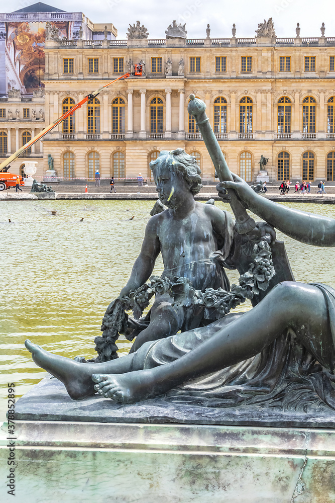 Antique Bronze sculpture at water parterre in Gardens of Versailles. France.