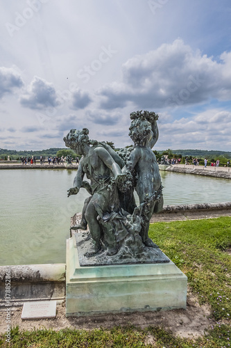 Antique Bronze sculpture at water parterre in Gardens of Versailles. France.